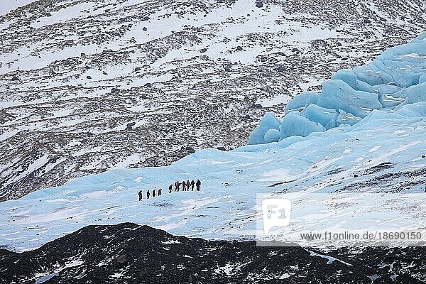 Tourists with guide visiting the glacier Falljökull  Falljoekull in winter in Austurland  part of Vatnajökull  largest ice cap in Iceland