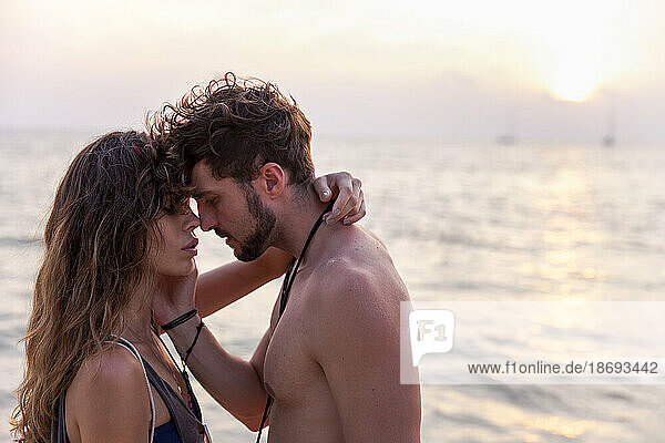 Romantisches Paar von Angesicht zu Angesicht vor dem Meer