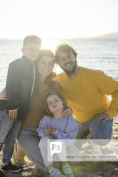 Happy family spending leisure time at beach on sunny day
