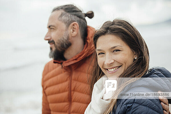Happy woman with man at beach