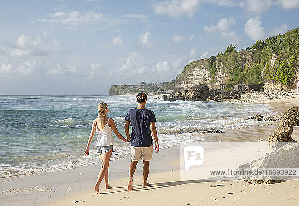 Young couple walking together at beach