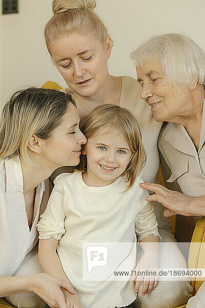 Multi-generation family with smiling girl at home