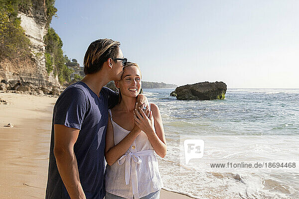 Romantic man enjoying vacation with girlfriend at beach