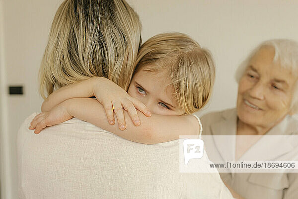 Daughter embracing mother at home