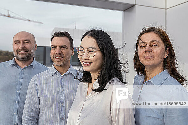 Confident business team on terrace of office building