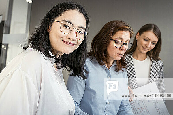 Smiling businesswoman working with colleagues on an architectural project