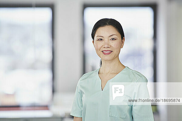 Portrait of smiling nurse in scrubs