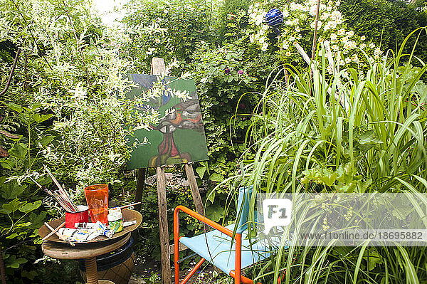 Painting amidst green plants at garden