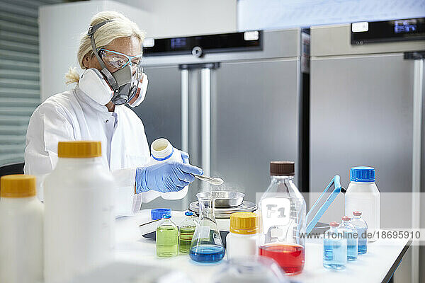 Scientist working with chemicals in laboratory