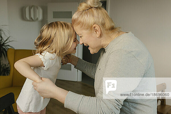 Grandmother playing with granddaughter at home