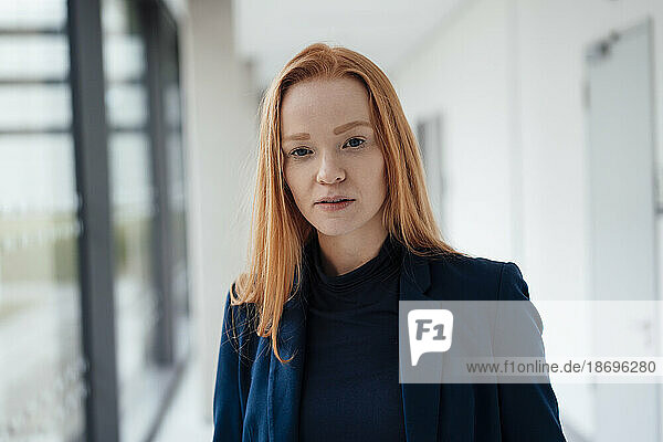 Redhead young businesswoman at office
