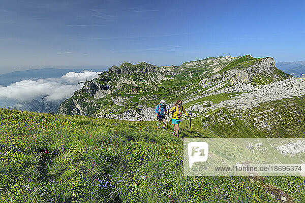 Italy  Province of Belluno  Pair of hikers following Alta Via Dolomiti Bellunesi trail