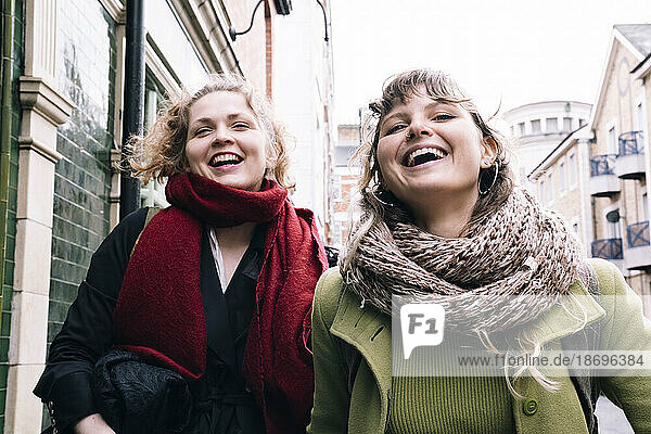 Happy female friends at street