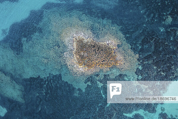 Spain  Balearic Islands  Formentera  Drone view of small Mediterranean islet