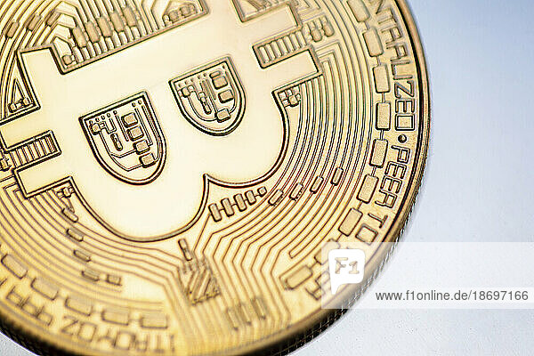 Close-up of gold colored Bitcoin coin