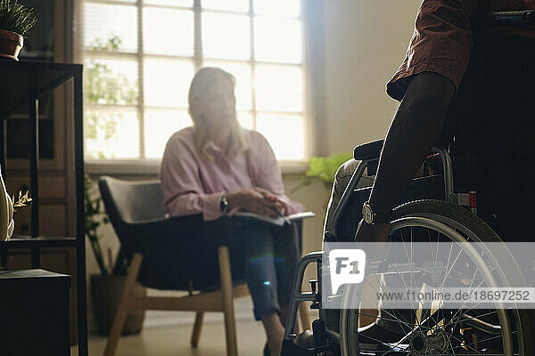 Patient with disability in therapy session with psychologist at office