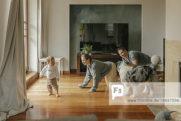Playful family spending leisure time in living room