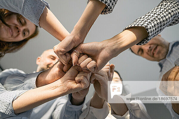 Business people putting their fists together