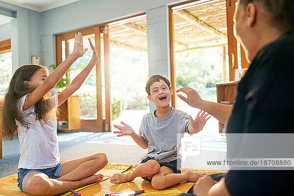 Happy boy with Down Syndrome playing on floor with family