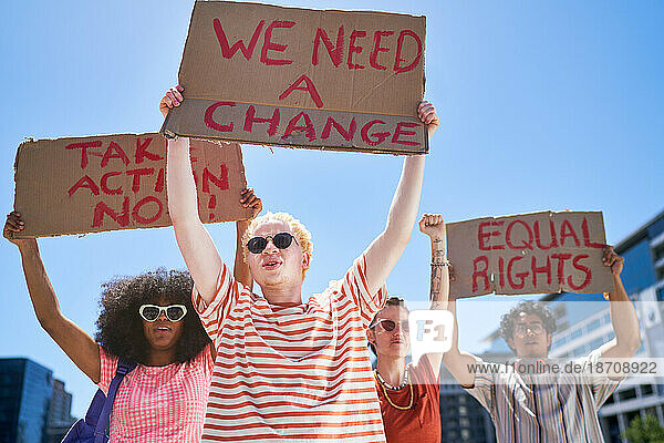 Young protester friends holding equal rights signs overhead