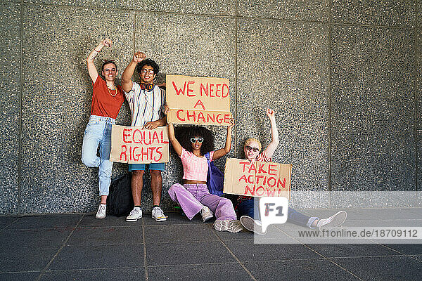 Portrait young protester friends holding equal rights signs