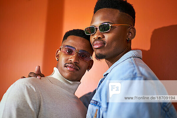 Portrait confident  cool young gay male couple in sunglasses