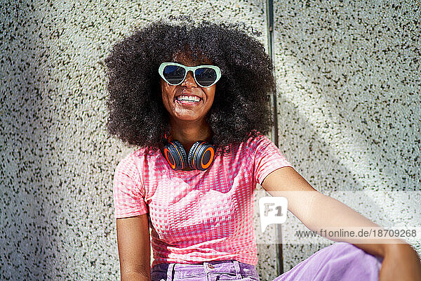 Portrait happy young woman in sunglasses with headphones