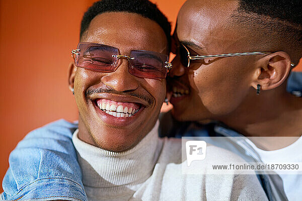 Close up portrait happy young gay male couple in sunglasses