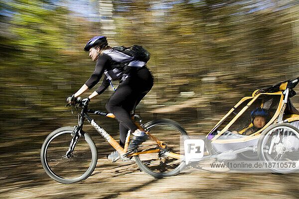 A mother bikes with her son in tow  Arkansas. (motion blur)