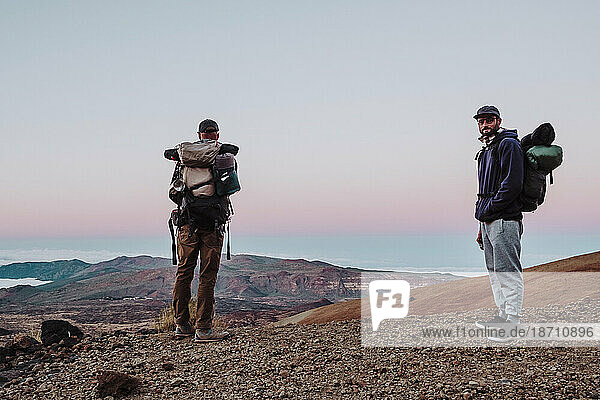 Hikers watching the sunset in a volcanic place