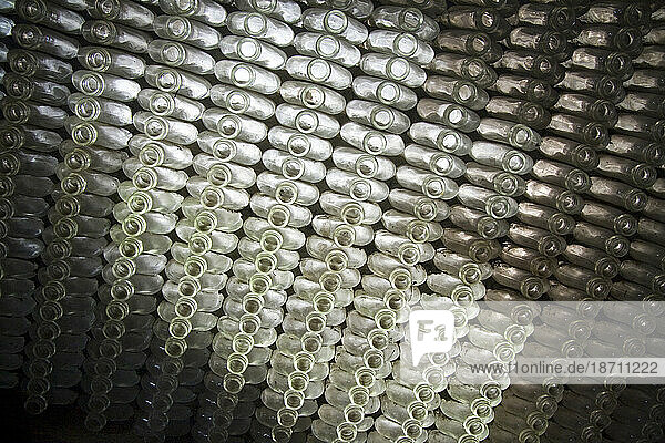 Empty glass bottles form a wall at an old winery warehouse in Ensanada  Baja California  Mexico.