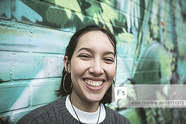 Multi ethnic woman with toothy smile.