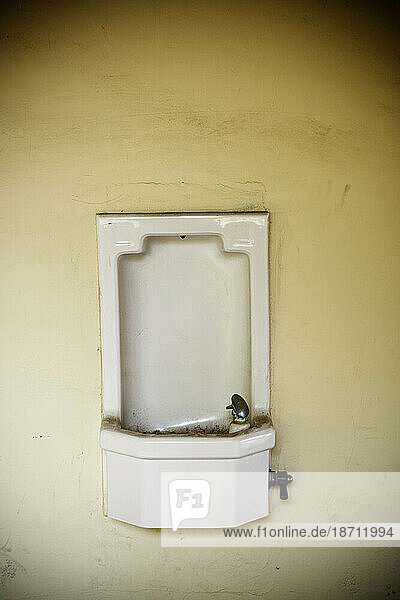 A porcelain wall mounted drinking fountain.