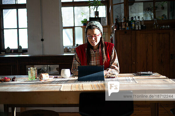 woman smiles while working at home freelance on ipad device