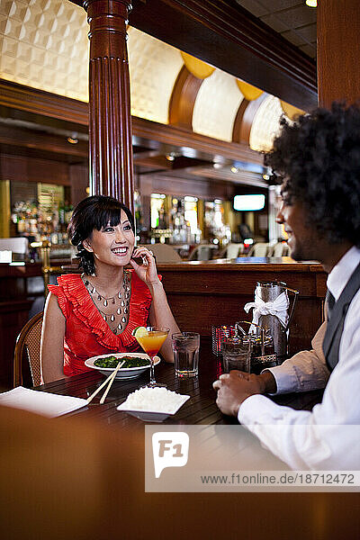 A man and a woman enjoy a meal of Asian fusion at a restaurant in Northeast Minneapolis  Minnesota.