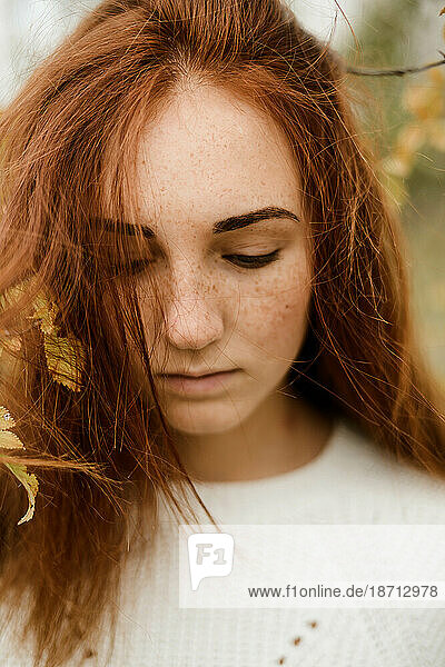 Close-up portrait of teenage girl with red hair