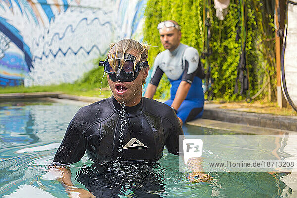 Portrait a young man with dive mask in pool in freediving training time.