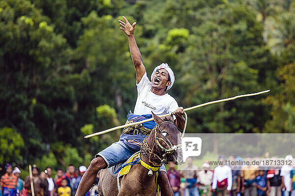Man riding horse and holding spear at Pasola Festival  Sumba island  Indonesia