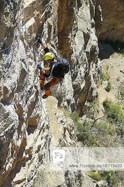 Climbing a ferrata route in San Blas  Arquillo reservoir in Teruel.