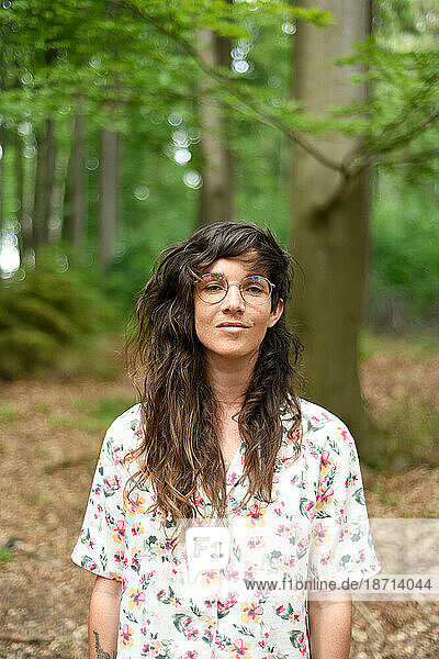 natural portrait of woman smiling peacefully in green Europe forrest