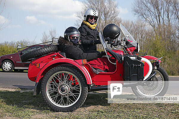 Two ladies preparing for a motorcycle sidecar adventure in Holland.