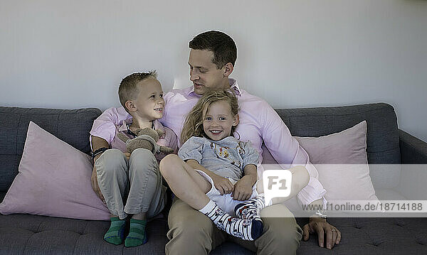 family portrait of a dad and his daughter and son at home