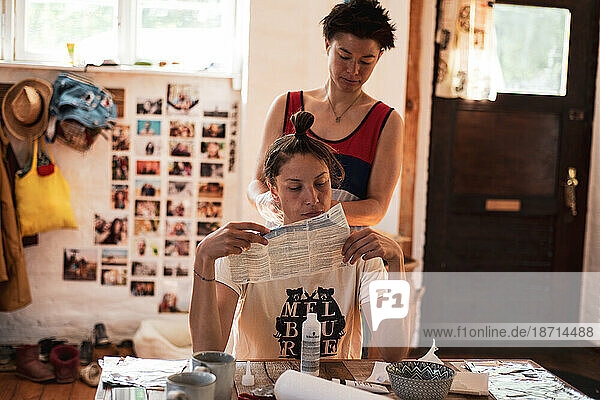 queer couple read instructions for hair bleach at home hair salon