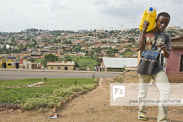 Man carrying water in Kigali  Rwanda