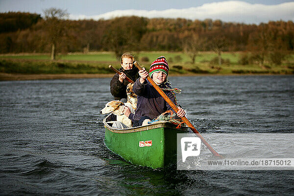 A family and their dogs take of for a canoeing adventure on a sunny but chilly day  near Ellingstring  North Yorkshire  England  UK  on March 22 2009.