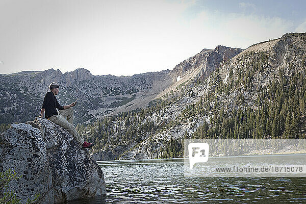 A man reads at Star Lake in the Sierra Nevada Mountains