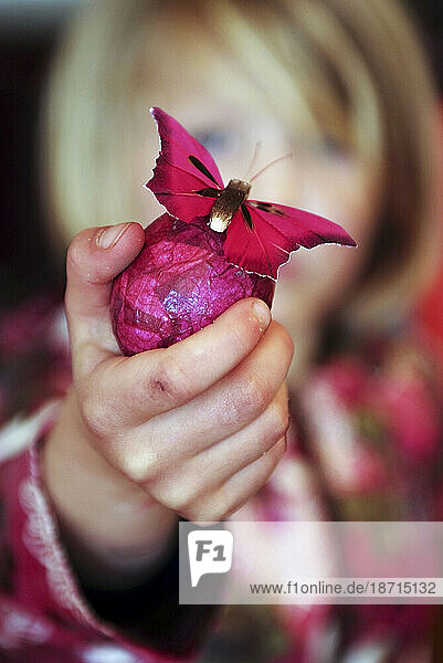 little girl with special butterfly Easter egg
