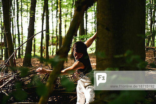 view through tree's of dancer in green sunlit forrest in germany
