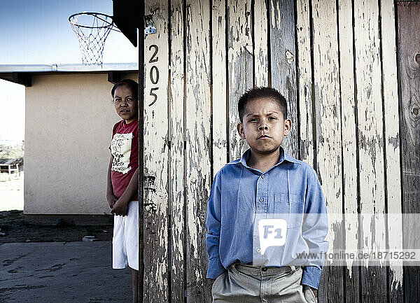A brother and sister wait for their mother to come back from work in Gallup