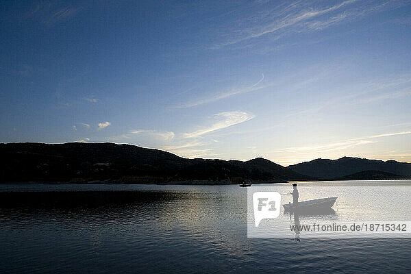 A man fishes for bass early in the morning at Lake Dixon in Escondido  California.